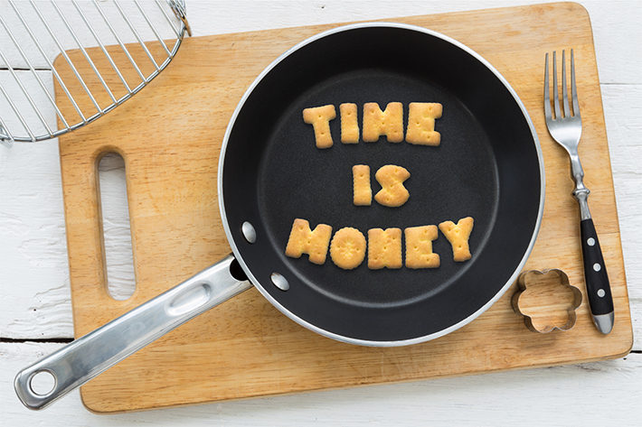 Letter biscuits quote TIME IS MONEY and cooking equipments.